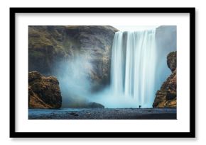 Couple of tourist near famous Skogafoss waterfall, Iceland