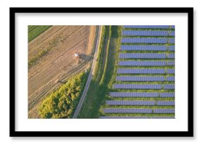 Top down view of the solar farm next to the agricultural field 