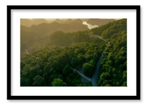Landscape of green mountains with curve highway road and lake in the morning. Nature landscape. Watershed forest. Water and forest sustainability concept. Aerial view of mountain with green trees.