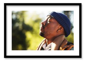 Breathing, fresh air and man in nature, calm or hiker on vacation in woods, wellness or backpacking. Hiking, backpacker and black person in forest, peace and mindfulness on holiday and free time