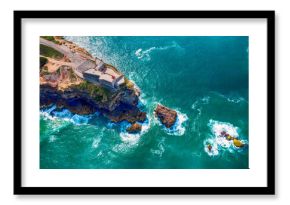 Rocky Cape with a lighthouse in the city of Nazare Portugal on the shores of the Atlantic Ocean