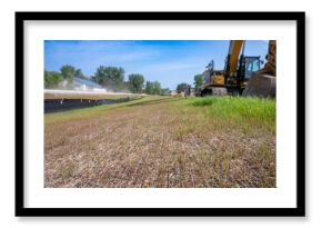 Woven straw mat used for stormwater erosion control with grass growing through 