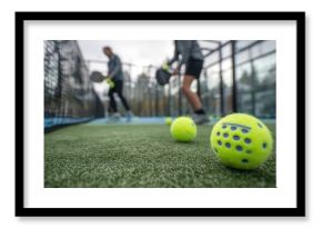 An action shot of padel players enjoying a game with innovative recycled padel balls emphasizing environmental responsibility in sports. Perfect for illustrating sustainability in athletic