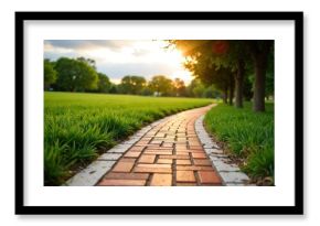 A brick pathway winds through a lush green park during sunset creating a peaceful outdoor scene