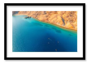 Rucica beach in Metajna  with paddle board on Pag island curved shoreline, crystal-clear turquoise sea, sunlit barren terrain and rocky Adriatic sea