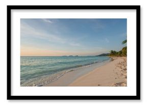 Secluded shoreline with ocean view and soft pastel sky.