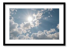Fluffy clouds under a glowing sun