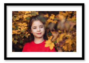 Girl in autumn nature, standing among autumn leaves.