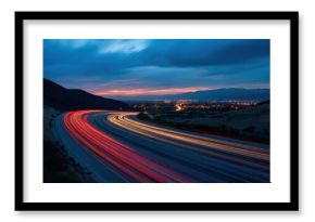 Highway at Dusk with Car Light Trails, City Lights, and Mountains in the Background