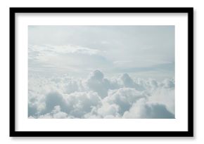 Cloudy sky background with thick, fluffy clouds in varying shades of blue, gray and white
