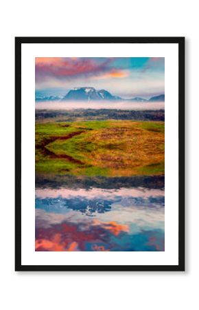 Typical Icelandic landscape with foggy mountains on the horizon.