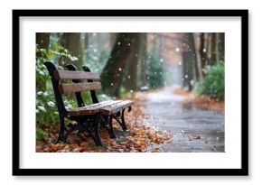 Empty park bench during a light snowfall