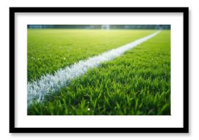 Green grass field with white sideline markers. Perfectly manicured lawn for sports matches. Stadium goal posts visible in distance, setting a competitive mood.