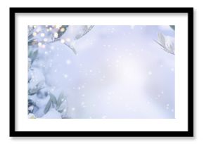 Olive branches in snow with bright bokeh lights. Horizontal background with atmospheric winter landscape for christmas greeting cards with space for text.