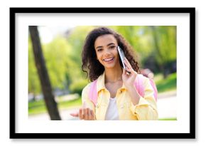 Portrait of attractive wavy hair cheerful girl good weather talk phone pink blackpack wear yellow jacket having fun outside outdoors