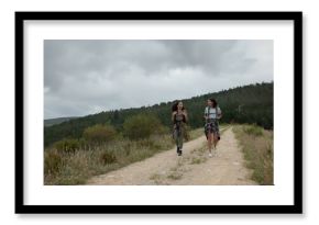 Friends, women in park and hiking in nature, walking and travel together with fun outdoor. Adventure, journey and fitness, sightseeing for tourism in environment and backpacking with trekking