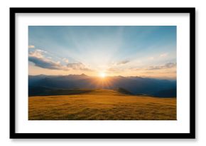 breathtaking sunset illuminates mountain range, casting golden rays over grassy landscape