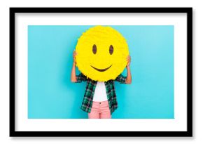 Photo of anonymous incognito lady hold emoji smile cover face wear plaid shirt isolated teal color background
