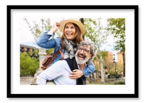 Happy married active senior couple enjoying summer vacation together in Barcelona