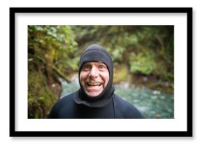 Portrait of man in wetsuit making a happy funny face