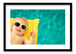 Funny baby boy in swimming pool