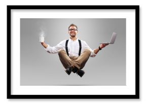 Young man is soaring in the air with a Cup of coffee and a laptop