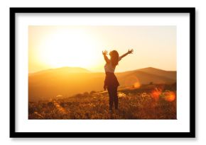 Happy woman jumping and enjoying life  at sunset in mountains.