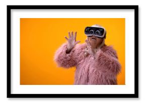 Senior woman in funny coat and VR headset playing video game, hi-end innovations