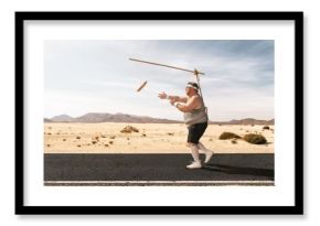 Funny overweight man chasing the hot dog on the stick through the empty road with copy space