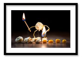 funny popcorn figure is holding a burning match on some corns to pop them up