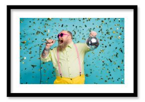 Portrait of his he nice attractive cheerful bearded mature guy holding in hand disco ball having fun singing karaoke isolated over bright vivid shine vibrant blue color background
