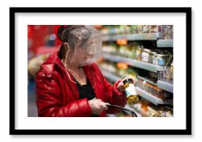 Coronovirus protection. Woman in a store with a plastic box on her face. A funny way to protect against COVID 19.Coronavirus and panic buying concept