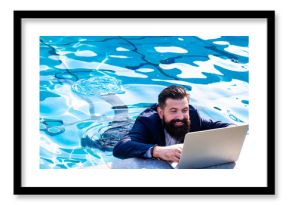 Business man in suit with laptop on swimming pool. Funny businessman relaxing with laptop.