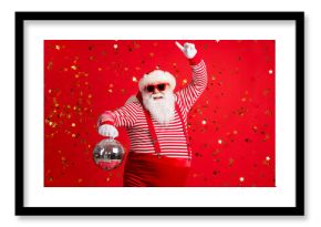 Photo of retired old man grey beard hold vintage disco ball dance funky wear santa x-mas costume suspenders sunglass gloves striped shirt cap isolated red color background