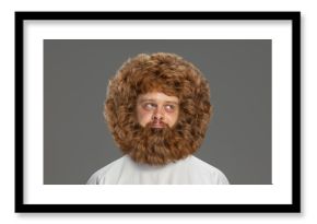 Half-length portrait of young very hairy man isolated over grey background.