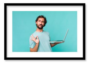 young adult hispanic crazy man with a laptop