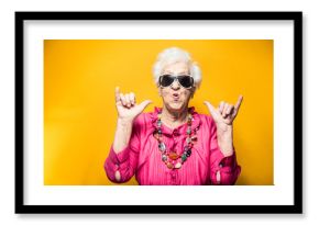 Grandmother colored portraits set in the studio. Concepts about seniority and third age. Funny old woman making party and celebrate 