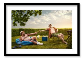 Two funny nerds relaxing in the backyard on the summer day