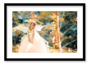 Fairy tale consept. Little toddler girl wearing beautiful princess dress with fairy wings