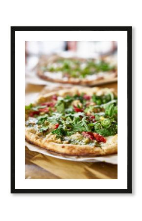 authentic oven fired pizza with pesto sauce and arugula