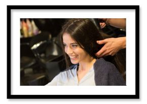 Young woman getting new hairstyle from hairdresser in the modern hair salon
