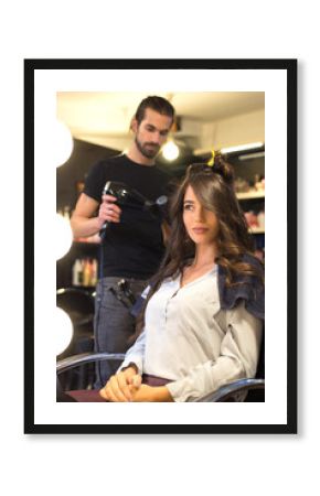 Young woman getting new hairstyle from hairdresser in the modern hair salon