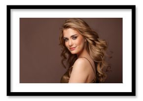 Beautiful glamorous model woman with long wavy and shiny hair against brown studio wall banner background