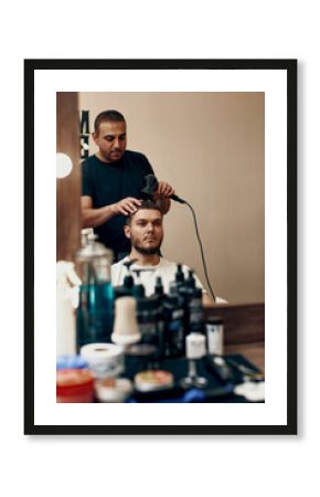 Hairdresser during work with client in barber shop