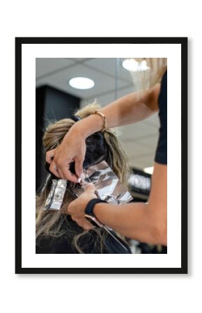 Hairstylist using foil to dye hair