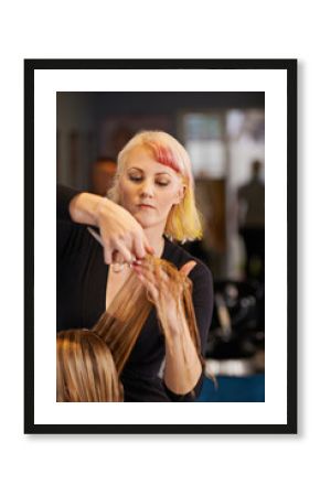 Maintaining her style. a female hairdresser cutting a clients hair.