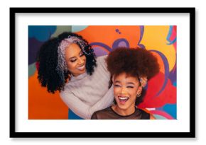 Happy hairdresser working on afro hair in hair salon