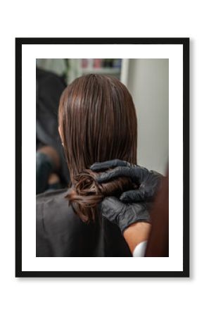 Portrait of a beautiful woman with long brown straight hair in a beauty salon.