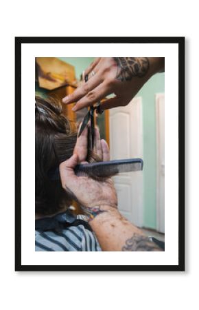 hairdresser cutting hair with scissors