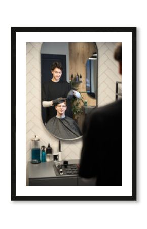 Diligent barber serving client in contemporary hairdressing salon